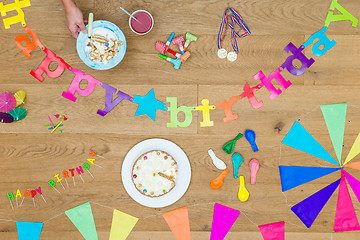 Image showing Cake And Birthday Decorations On Wooden Table