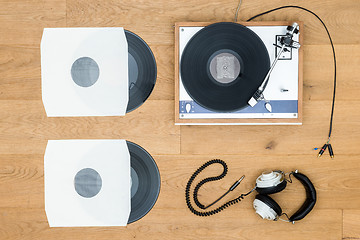 Image showing Vintage Turntable And Records On Wooden Table