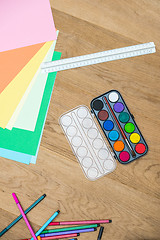 Image showing Watercolor Paints With Craft Papers On Table