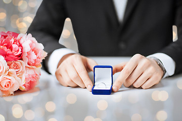 Image showing close up of man with gift box and engagement ring