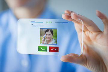 Image showing close up of woman with transparent smartphone