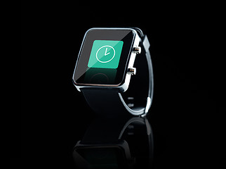 Image showing close up of black smart watch with clock icon