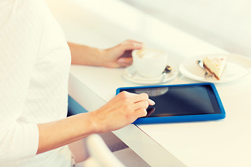 Image showing close up of woman with tablet pc drinking coffee