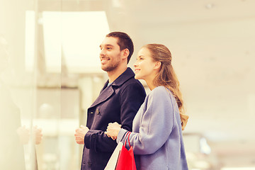 Image showing happy young couple with shopping bags in mall