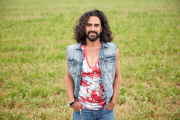 Image showing smiling young hippie man on green field