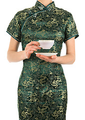 Image showing Woman in Chinese dress holding a cup of tea
