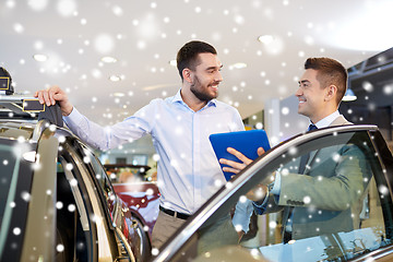 Image showing happy man with car dealer in auto show or salon