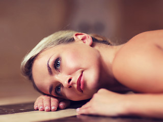 Image showing young woman lying on hammam table in turkish bath