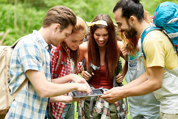 Image showing happy friends with backpacks and tablet pc hiking