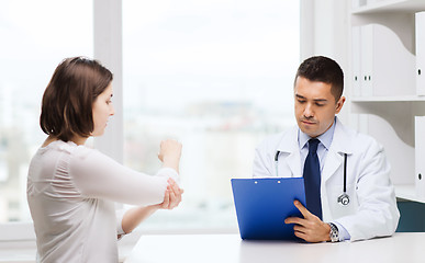 Image showing doctor and young woman meeting at hospital