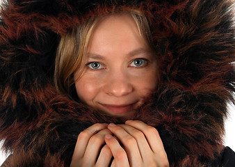 Image showing Smiling young woman with a fur hood