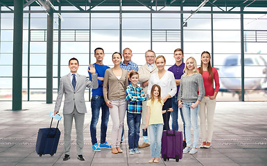 Image showing group of smiling people over airport terminal