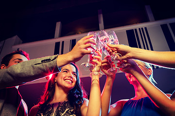 Image showing smiling friends with glasses of champagne in club