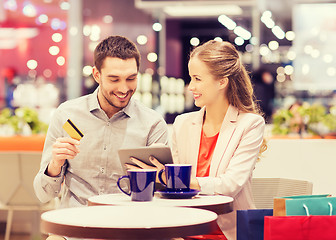 Image showing couple with tablet pc and credit card in mall