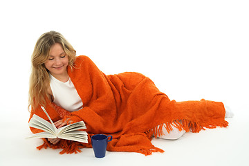 Image showing Cozy girl reading a book, smiling