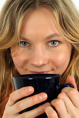 Image showing Charming young woman drinking tea