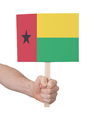 Image showing Hand holding small card - Flag of Guinea Bissau