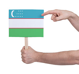 Image showing Hand holding small card - Flag of Uzbekistan