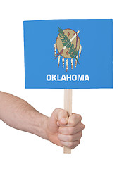 Image showing Hand holding small card - Flag of Oklahoma