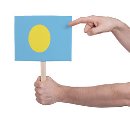 Image showing Hand holding small card - Flag of Palau