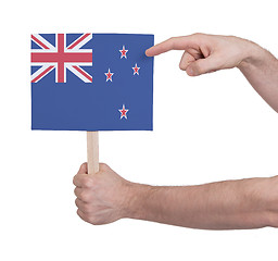 Image showing Hand holding small card - Flag of New Zealand