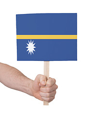 Image showing Hand holding small card - Flag of Nauru