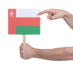 Image showing Hand holding small card - Flag of Oman