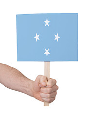 Image showing Hand holding small card - Flag of Micronesia