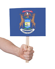 Image showing Hand holding small card - Flag of Michigan