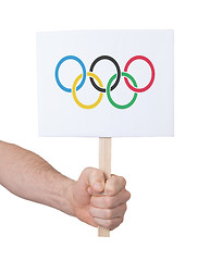 Image showing Hand holding small card - Flag of the Olympic games