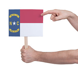 Image showing Hand holding small card - Flag of North Carolina