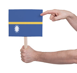 Image showing Hand holding small card - Flag of Nauru