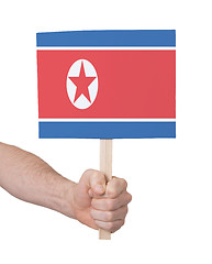 Image showing Hand holding small card - Flag of North Korea