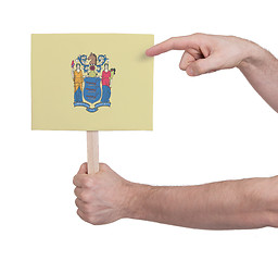 Image showing Hand holding small card - Flag of New Jersey