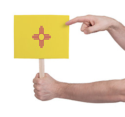 Image showing Hand holding small card - Flag of New Mexico