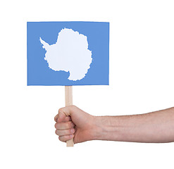 Image showing Hand holding small card - Flag of Antarctica