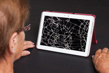 Image showing Senior lady with tablet, cracked screen