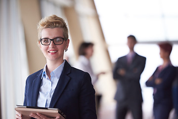 Image showing business woman  at office with tablet  in front  as team leader