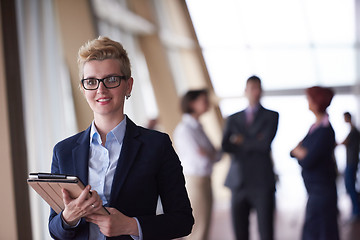 Image showing business woman  at office with tablet  in front  as team leader