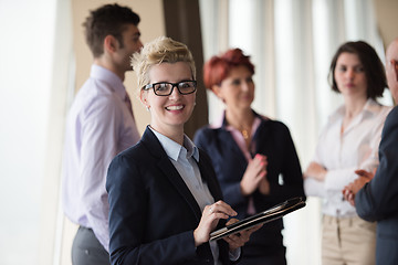 Image showing business woman  at office with tablet  in front  as team leader