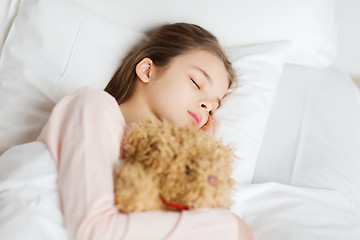 Image showing girl sleeping with teddy bear toy in bed at home