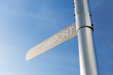 Image showing close up of airport signpost over blue sky