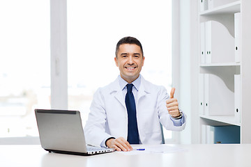 Image showing smiling doctor showing thumbs up in medical office