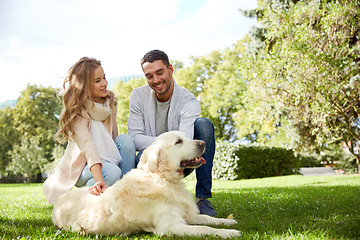 Image showing happy couple with labrador dog walking in city