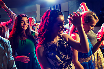 Image showing smiling friends dancing in club