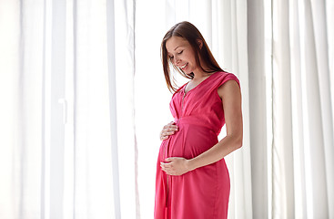 Image showing happy pregnant woman with big tummy at home