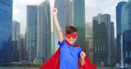 Image showing boy in red super hero cape and mask showing fists