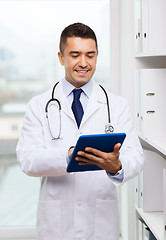 Image showing smiling male doctor in white coat with tablet pc