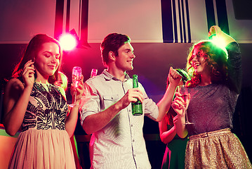 Image showing smiling friends with wine glasses and beer in club