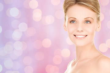 Image showing lovely woman face over pink lights background